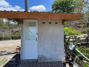 a door to a house with a wooden roof at Kertasari Golden House Homestay in Pulau Sarang +9 photos