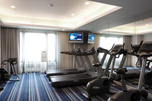 a gym with several tread machines in a hotel room at Grand Victoria Hotel in Taipei