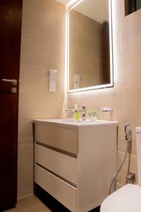 a bathroom with a sink and a mirror at Urban Oasis, Tri-Zen Luxury Apartment in Central Colombo in Colombo