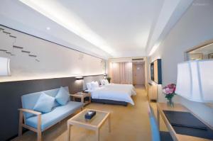 Ένα ή περισσότερα κρεβάτια σε δωμάτιο στο Guangzhou Suntec Hotel +1 φωτογραφίες