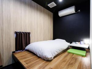 Tabist machinoyado denden客房内的一张或多张床位