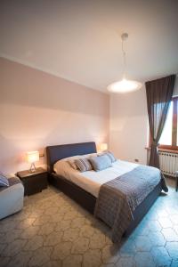 a bedroom with a large bed and a window at Bed and Breakfast Welcome in Sarzana