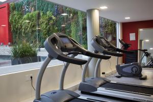 two exercise bikes in a gym with a window at Regency Way Montevideo Hotel in Montevideo