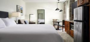 a bedroom with a white bed and a dining room at Marriott Willow Ridge Luxury Studio in Branson +29 photos