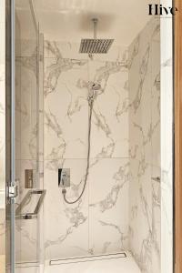 a bathroom with a shower with marble walls at Luxury 2 Bed in Address Opera Residences in Dubai