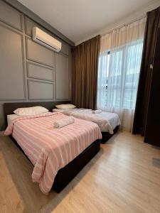 a hotel room with two beds and a window at Arte Plus Ampang City 7Pax-3BR-2CP in Kuala Lumpur