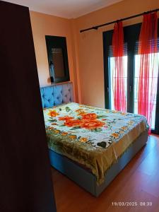 a bedroom with a bed with orange flowers on it at House with view in Levkopiyí