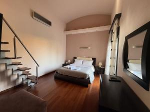 a hotel room with a bed and a staircase at Residenza di Lusso in Chios