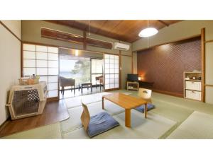 a room with a living room with a table and a living room at Japari Tateyama - Vacation STAY 75921v in Tateyama