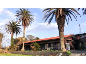 two palm trees in front of a building at Japari Tateyama - Vacation STAY 75921v in Tateyama