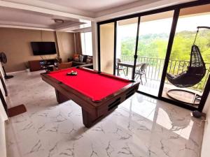 a pool table in a living room with a view at Overlooking & Serene Resthouse wt Pool in Antipolo in Antipolo