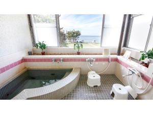 a bathroom with a tub and a toilet and a sink at Japari Tateyama - Vacation STAY 75921v in Tateyama