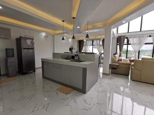 a large kitchen and living room with a counter top at Overlooking & Serene Resthouse wt Pool in Antipolo in Antipolo
