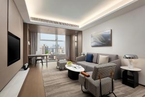 a living room with a couch and a table at Modena By Fraser Shenzhen in Shenzhen