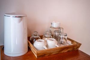 a wooden tray with glass jars and a jug on a table at Asasta Kintamani Villa in Kubupenlokan