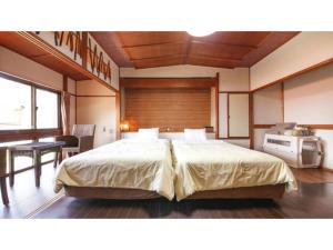 a bedroom with a large bed in a room at Japari Tateyama - Vacation STAY 84018v in Tateyama