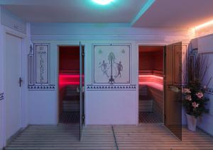 a hallway with two entrances to a room with beds at Parkhotel Fedora in Campitello di Fassa +27 photos