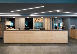 a lobby with a reception desk in a building at Parkhotel Fedora in Campitello di Fassa