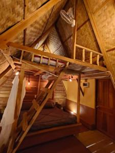 an attic room with a bunk bed in a cabin at Fandee Island - Treehouses, Tiny Houses & Zipline - Tad Lo, Boloven Loop Pakse in Tad Lo