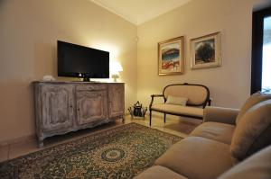 a living room with a flat screen tv and a couch at Villa Il Mio Paradiso in Fasano
