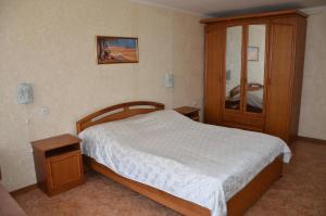 a bedroom with a bed and a wooden cabinet at Apartment on Ingenernaya 17 in Mykolaiv