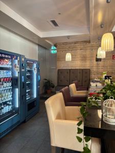 a waiting room with a drink machine in a restaurant at Alpenresidenz Turracher Höhe by ALPS RESORTS in Turracher Hohe