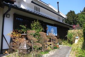 a building with a sign on the side of it at Minshuku Murou in Uda