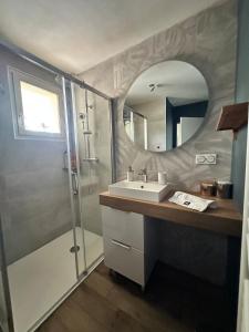 a bathroom with a sink and a shower with a mirror at L Elegant Cozy Plein Centre in Saint-Avertin +17 photos