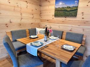 a dining room with a wooden table and chairs at Ferienhaus Muskatellerhof in Silz