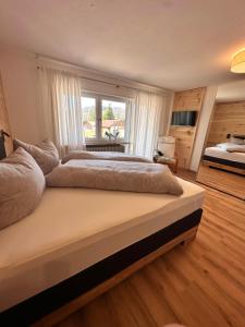 a large bedroom with a large bed and a window at Ferienhaus Muskatellerhof in Silz