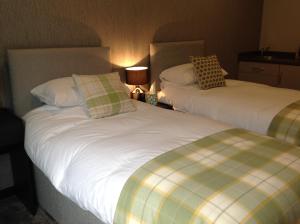 a hotel room with two beds and two lamps at Rooms @ Number Six in Oakham