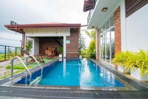 a swimming pool in the backyard of a house at Thimaya Holiday Resort in Hatton
