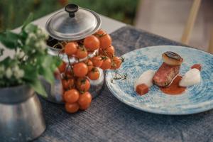 a blue plate with meat and vegetables on a table at Lindos Imperial Resort & Spa in Kiotari