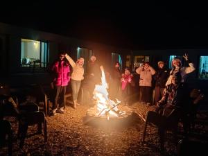 a group of people standing around a fire at Mystic Pangong in Spangmik
