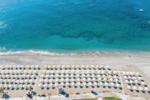 an aerial view of a beach with a bunch of umbrellas at Lindos Imperial Resort & Spa in Kiotari