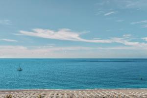 a boat in the middle of a large body of water at Lindos Imperial Resort & Spa in Kiotari