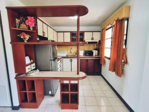 a small kitchen with a island in the middle at Oceanside Place Beach Resort in Ban Tha Fat