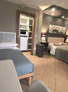 a hotel room with two beds and a kitchen at B&B Il Tramonto in Pastrengo