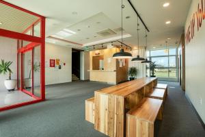 an office with a wooden bench in the middle at Dodubong Stay Hotel in Jeju