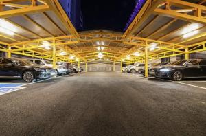 a parking garage with cars parked in it at night at Awesome Boutique Hotel in Gwangju