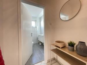 a bathroom with a mirror and a sink at Cosy Apartments in Hannover