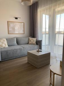 a living room with a couch and a coffee table at Panorama View II in Veľký Slavkov