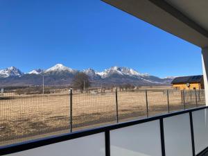 a view of snow covered mountains from a window at Panorama View II in Veľký Slavkov