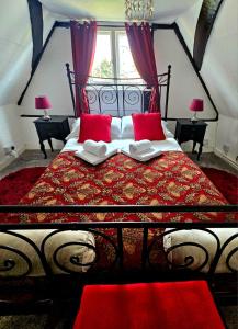 a bedroom with a large bed with red pillows at Crooked Loft in Rye