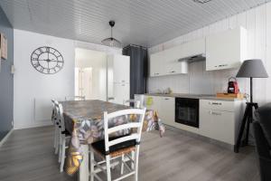 a kitchen with a table and chairs in a kitchen at Le Reflet des Pyrénées in Bagnères-de-Bigorre