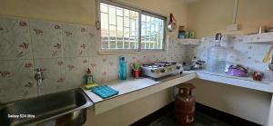 a small kitchen with a sink and a sink at 'Kuwoli' By Happy Homes in Tezpur