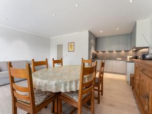 a kitchen and dining room with a table and chairs at ZAND III 0202 De Panne in De Panne +2 photos