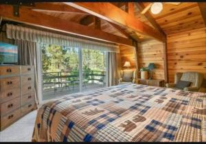 a bedroom with a bed and a large window at The Bears Lair Perfect for family w-full Amenities in Big Bear City