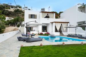 a villa with a swimming pool in front of a house at Sea and sun in Nísos Skýros