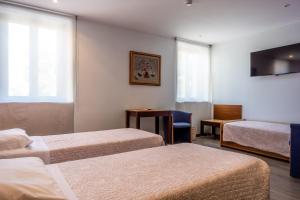 Postel nebo postele na pokoji v ubytování Hotel San Giorgio